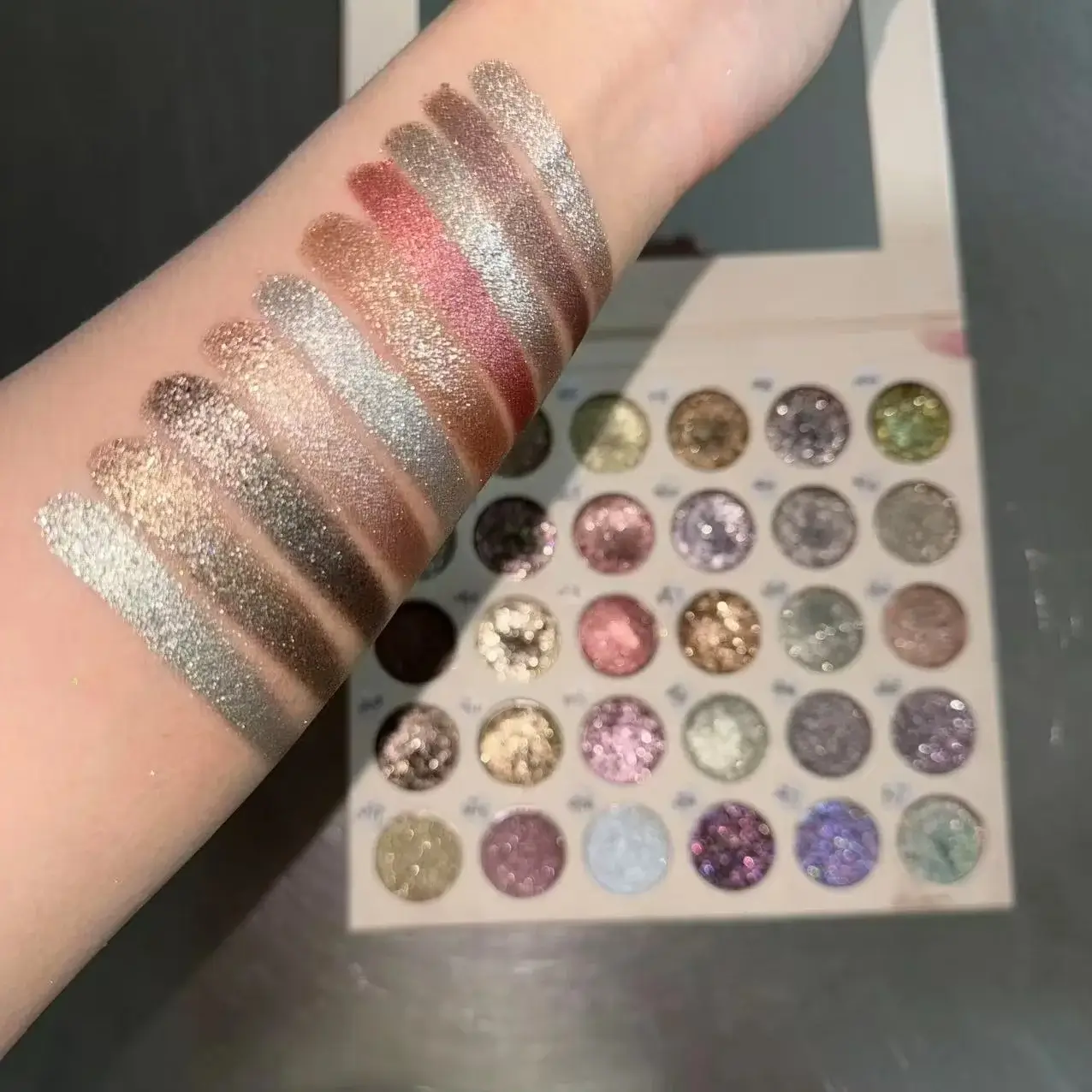 Custom metallic eyeshadow palette and reflective swatches
